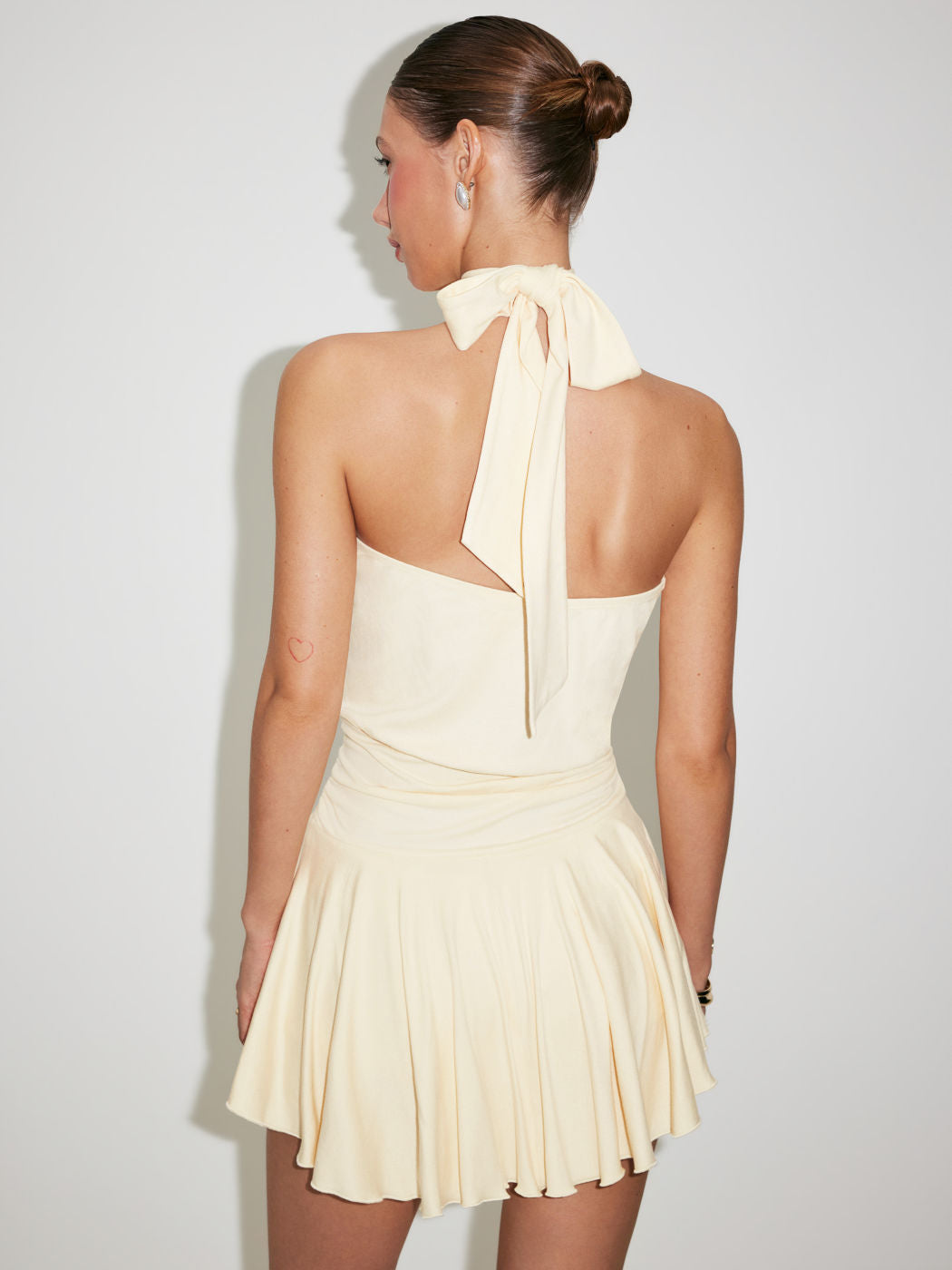 Backless halter-neck dress with a fitted waist