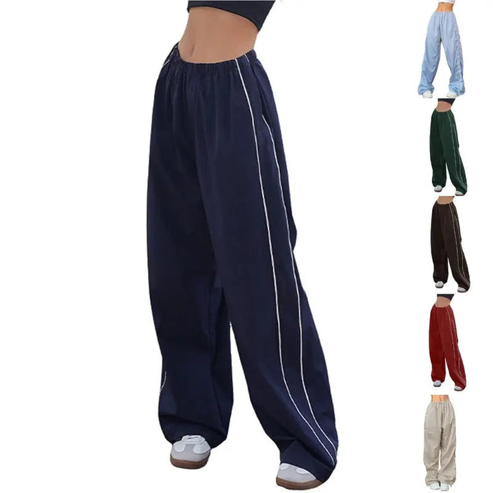 Navy blue wide-leg pants with white stripes on a white background, featuring the brand 